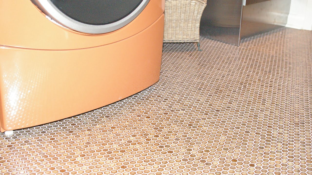 Small hexagon floor tiles in a laundry room