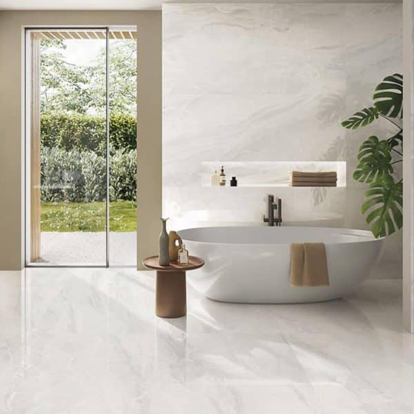 Beautiful room scene displaying white marble look porcelain tiles on walls and floor of the bathroom